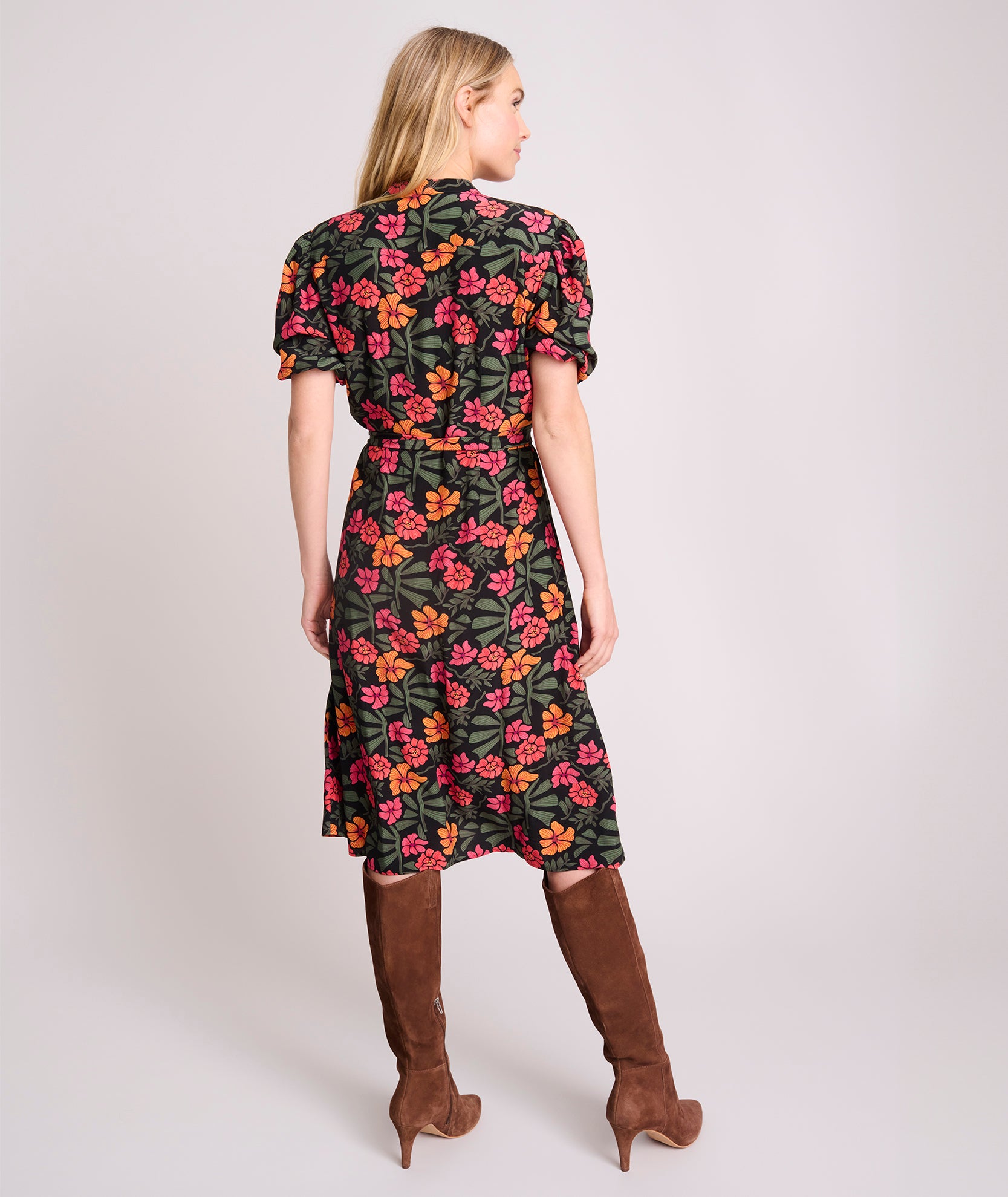 Model is wearing UNTUCKit Short Sleeve Fall Floral Midi Alix Dress in Black Orange Pink Floral Print.