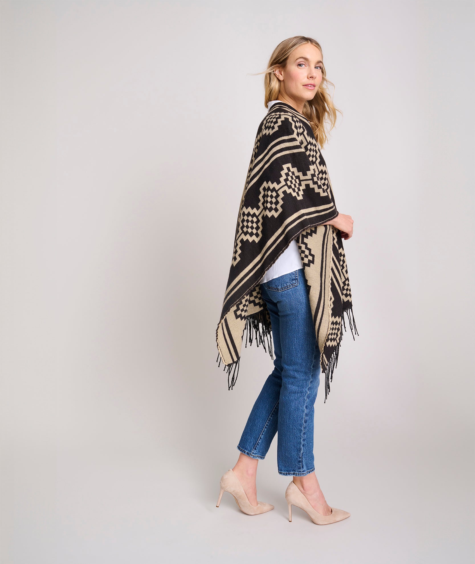 Model is wearing UNTUCKit Fringe Trim Geo Print Poncho.