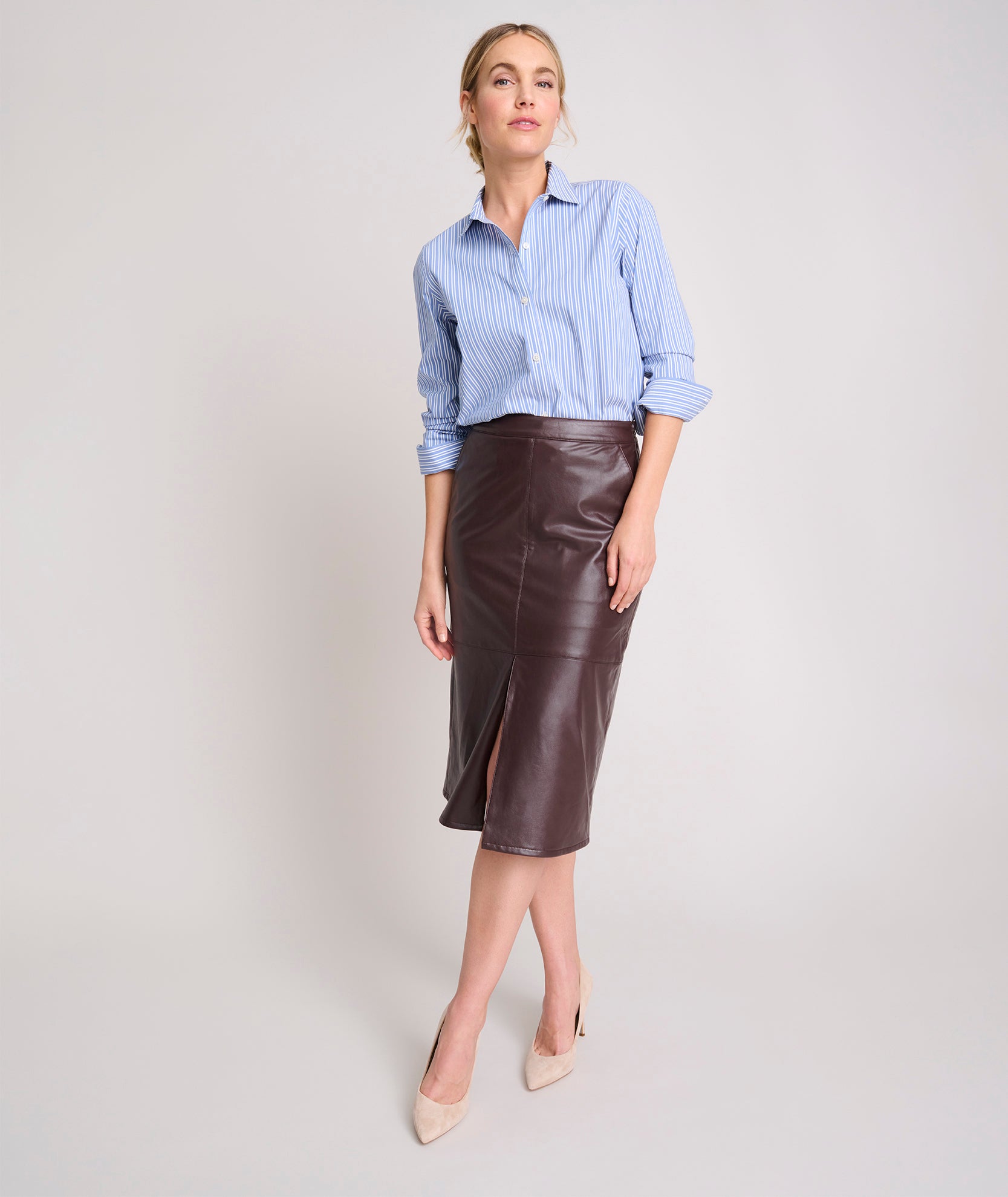 Model is wearing UNTUCKit Faux Leather Penicli Aubrey Skirt.