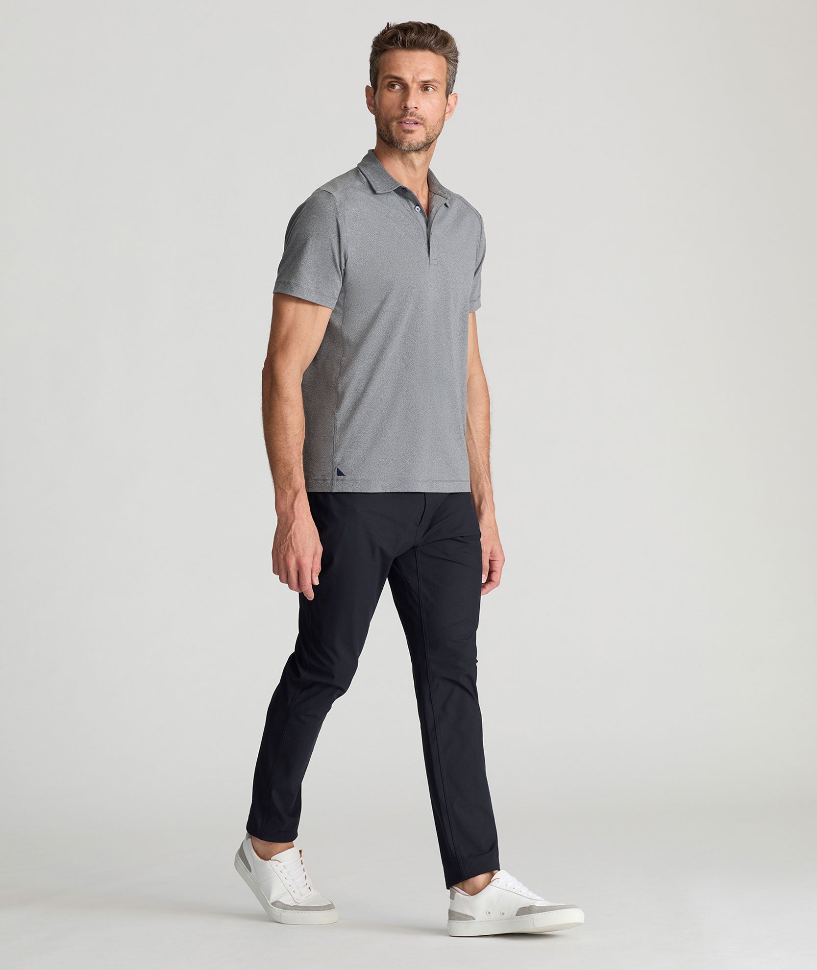 Model is wearing UNTUCKit 5-Pocket Tech Pant in Black.