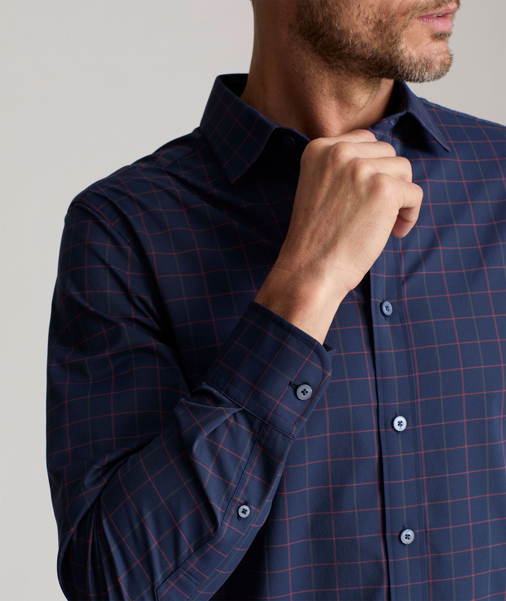 Model is wearing UNTUCKit Wrinkle-Free Performance Altrugo Shirt in Navy Windowpane Check. 