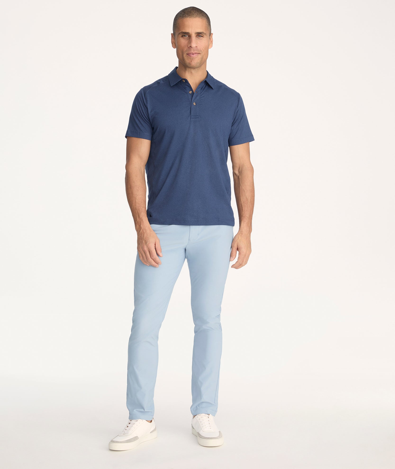 Model is wearing UNTUCKit Treveler Tech Pants in Sea Blue - full body