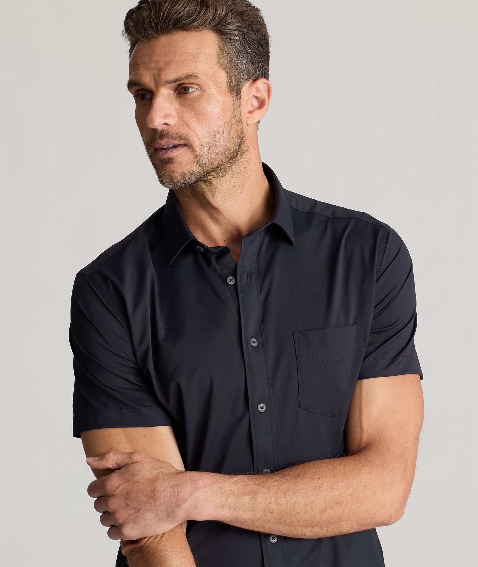 Model wearing an UNTUCKit Black Wrinkle-Free Performance Short Sleeve Gironde Shirt