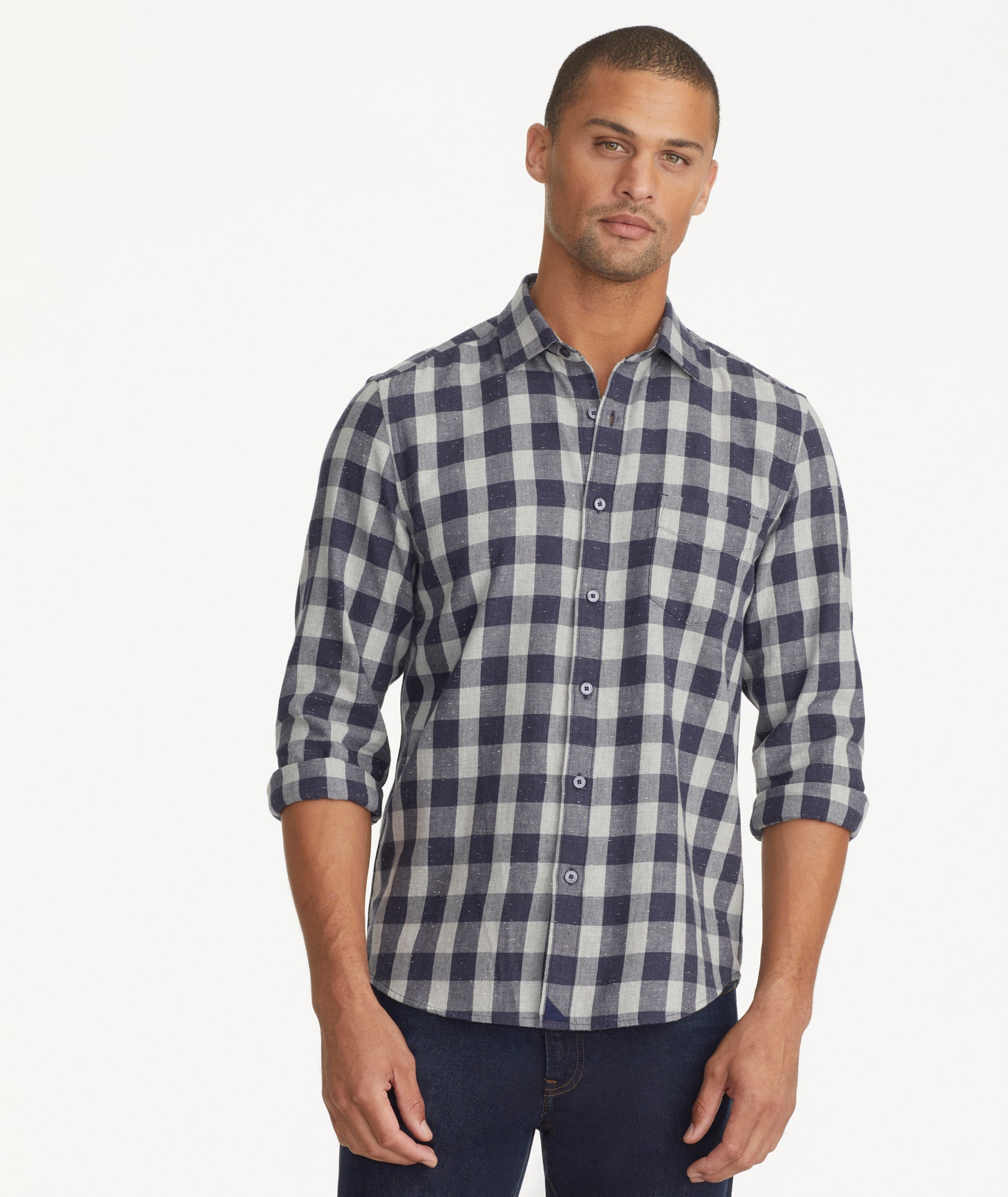 Model is wearing UNTUCKit gray and navy Buffalo check flannel.