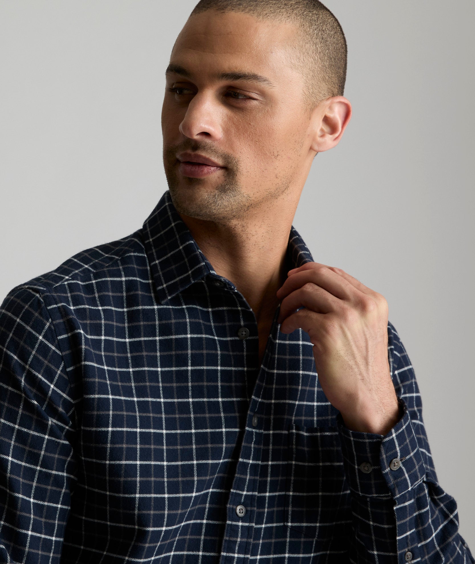 Model is wearing UNTUCKit Flannel Morisco Shirt in Navy & White Windowpane Check