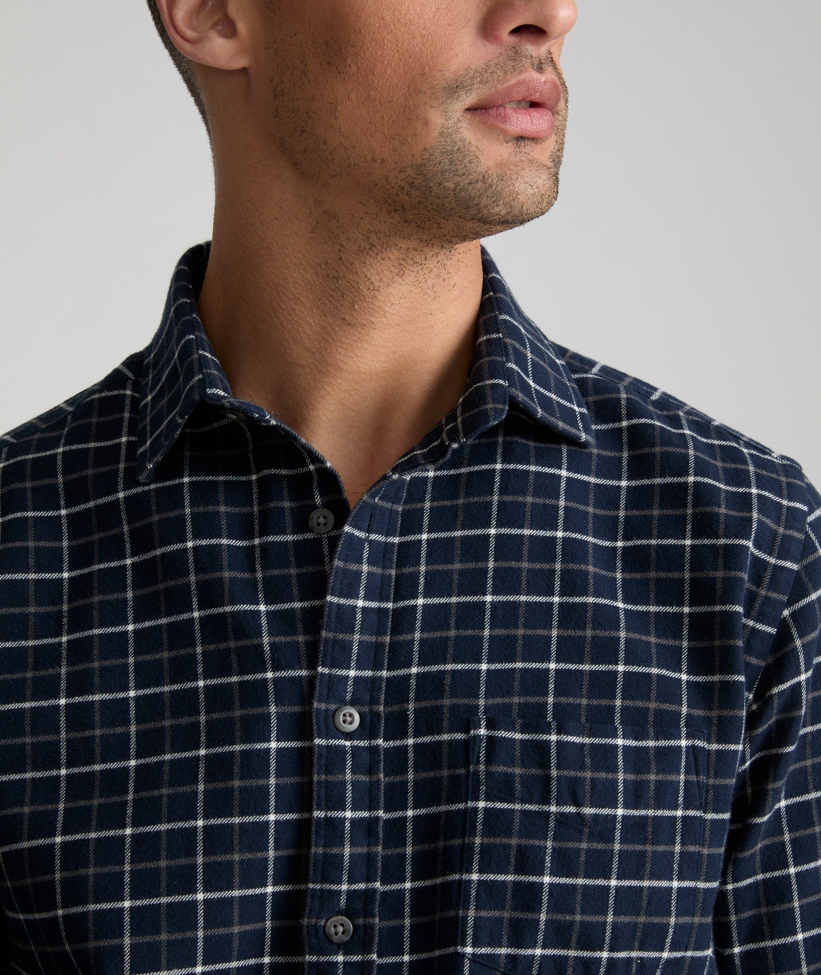 Model is wearing UNTUCKit Flannel Morisco Shirt in Navy & White Windowpane Check