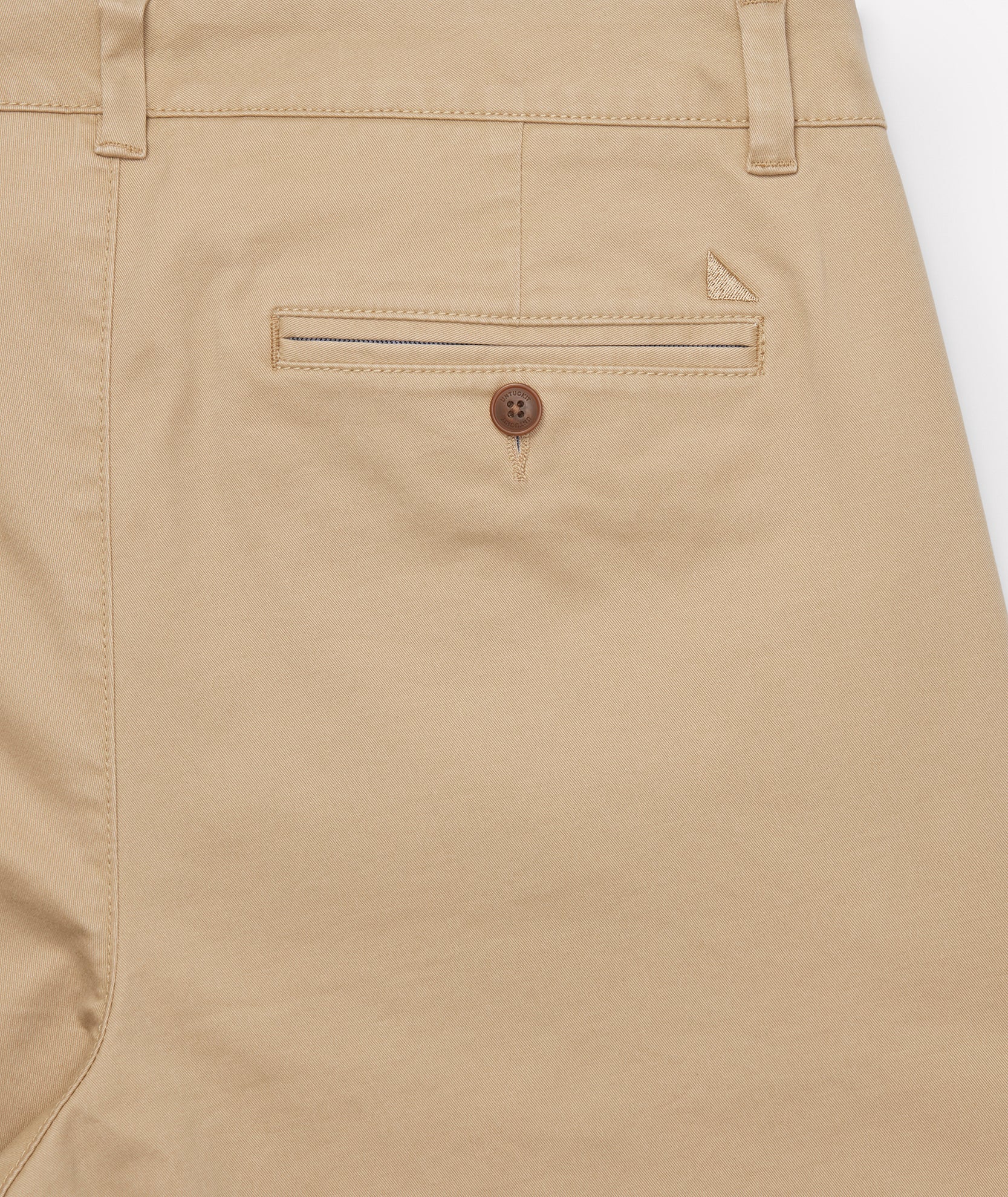 Model is wearing UNTUCKit Classic Chino Pants in Khaki.