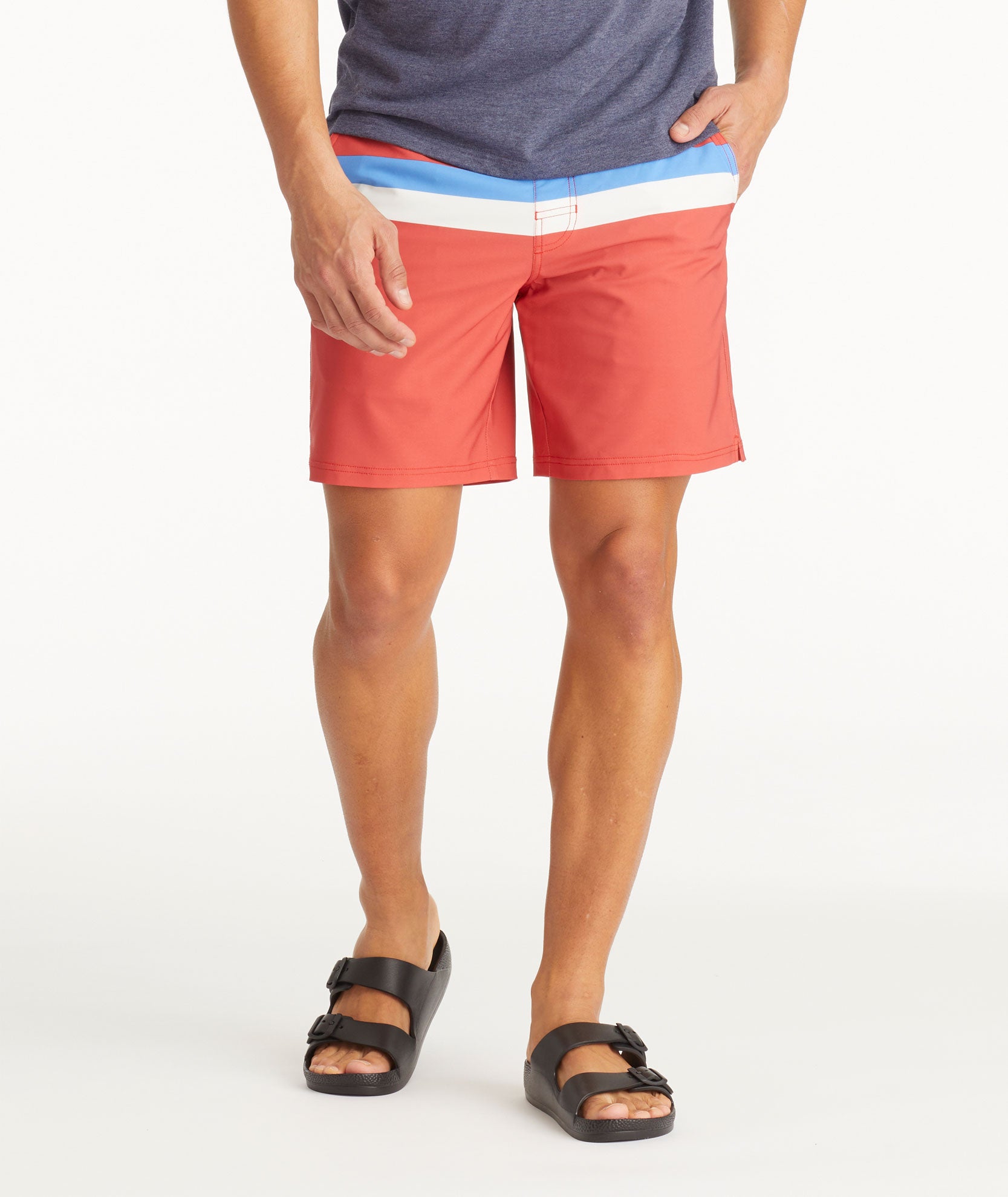 Model wearing UNTUCKit Mid Red 7-Inch Recycled Swim Trunks