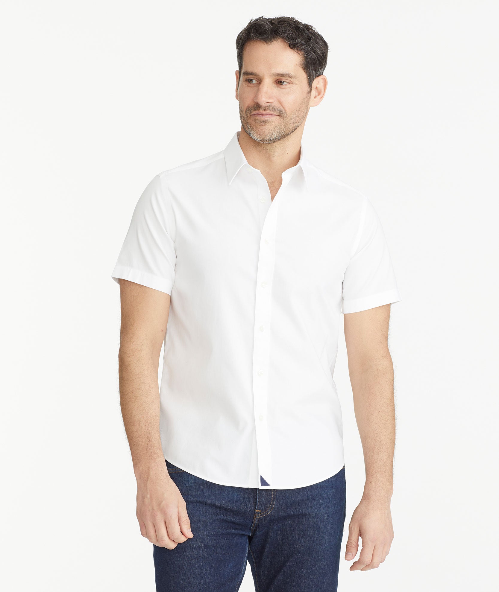 Model is wearing UNTUCKit White Wrinkle-Free Short-Sleeve Las Cases Shirt