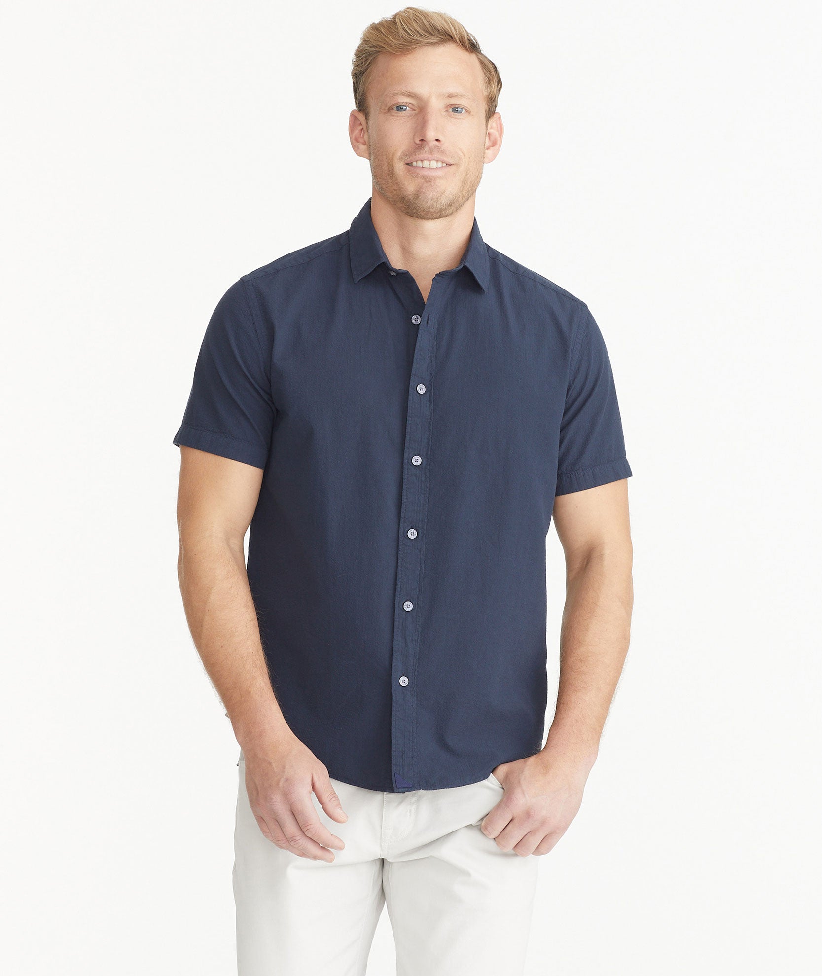 Model is wearing UNTUCKit Navy Cotton Seersucker Short-Sleeve Pavao Shirt.